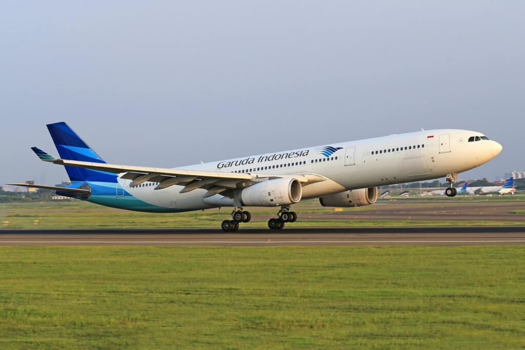 Garuda Indonesia Airbus lifting off from the runway, capturing the excitement of air travel.