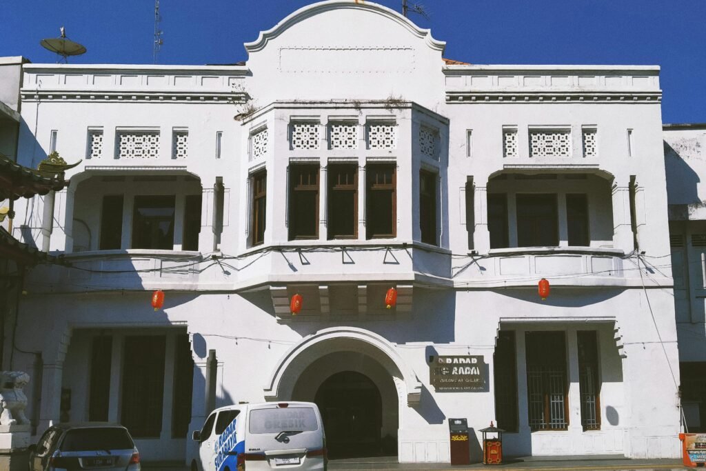 Elegant white colonial building with intricate details in Surabaya, East Java, Indonesia.